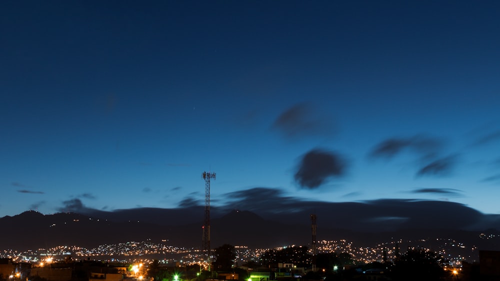 a view of a city at night from a hill