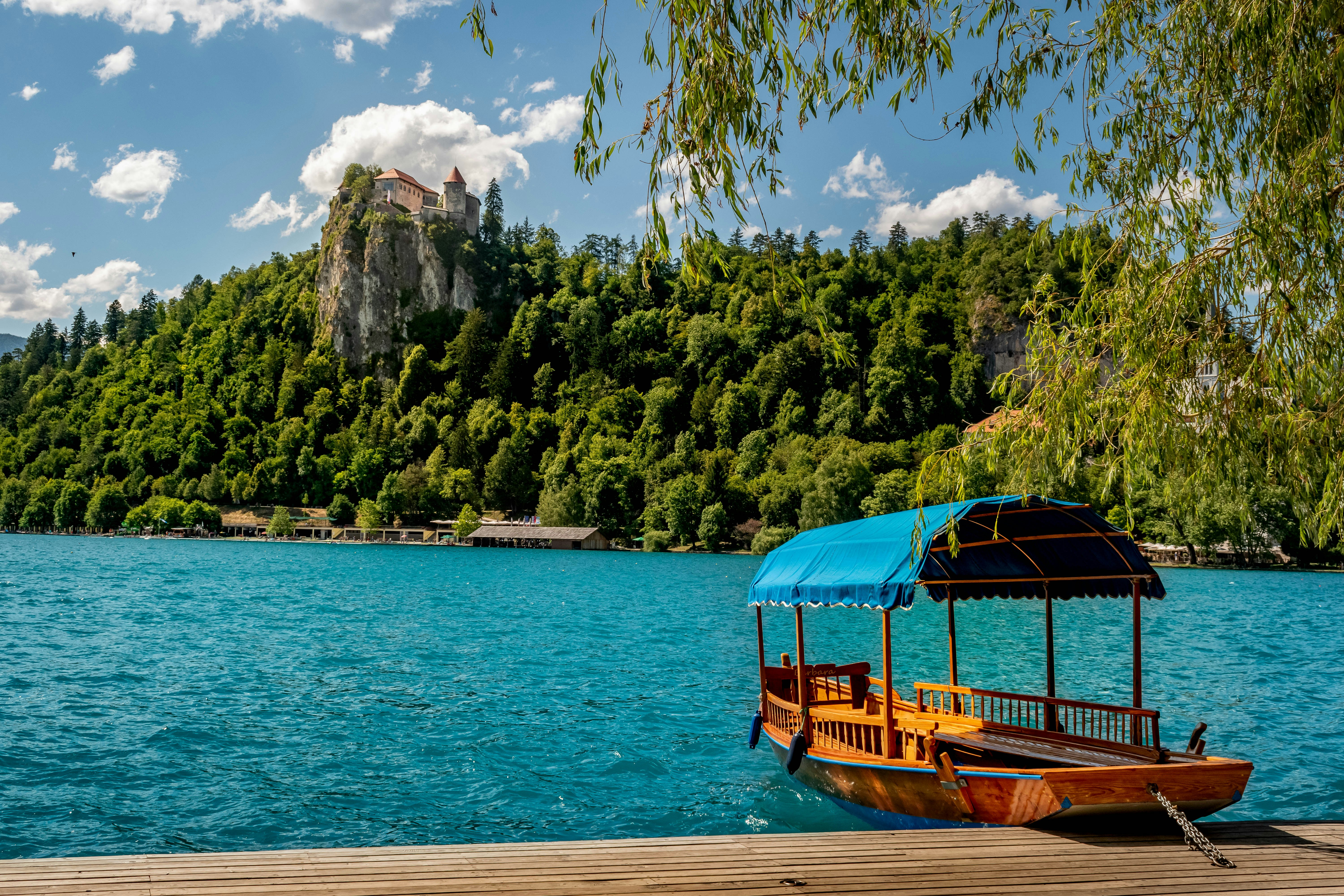 a boat on a lake with a mountain in the background