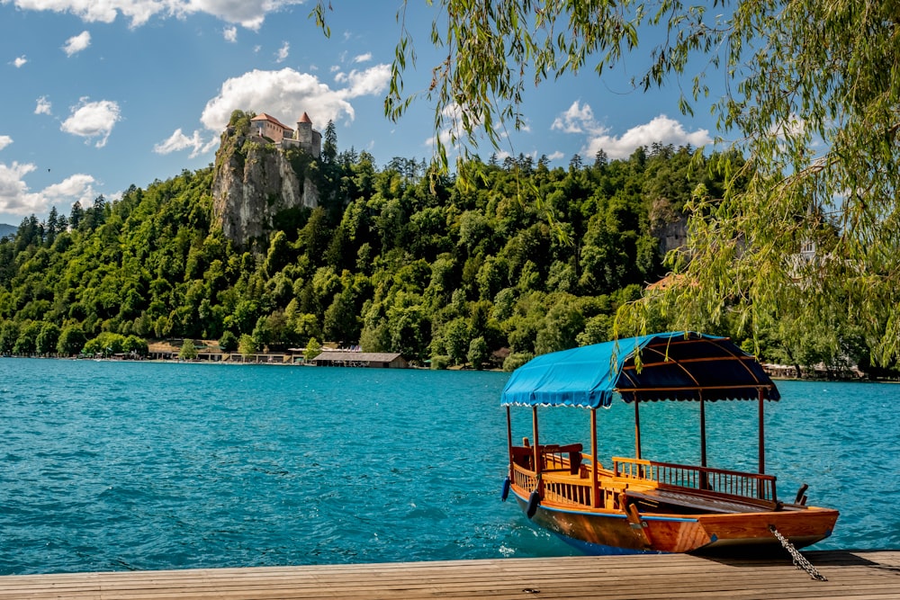 a boat on a lake with a mountain in the background