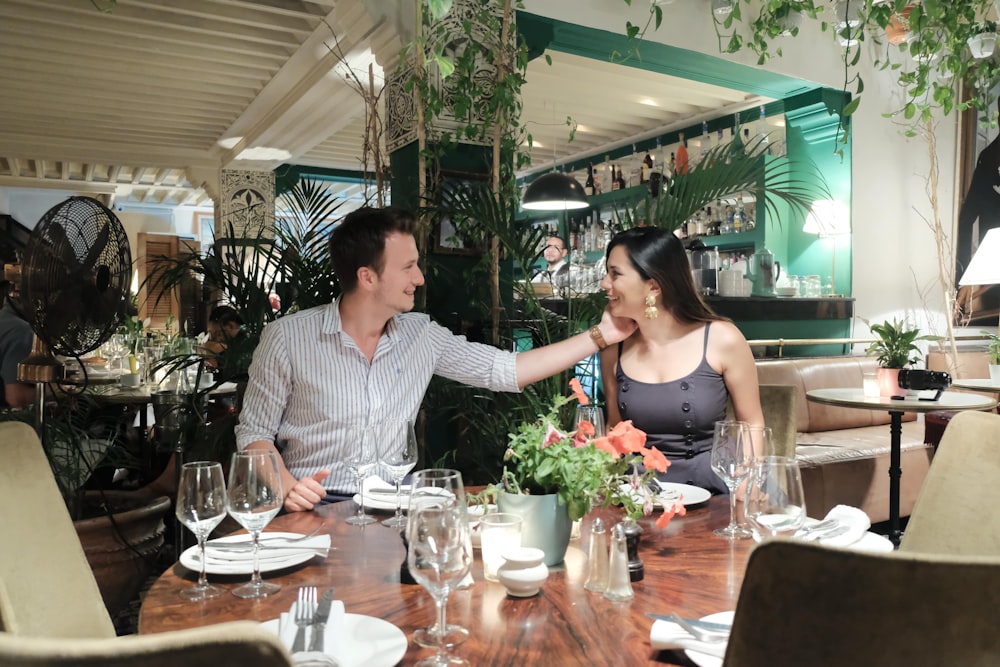 a man and woman sitting at a table in a restaurant