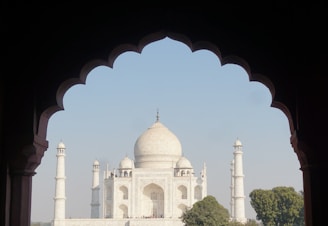 A stunning view of the Taj Mahal at sunset, showcasing its majestic architecture and reflecting pool.