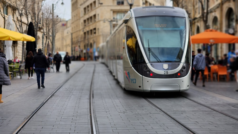 a tram is traveling down the street in the city