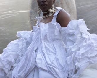 a woman in a white dress standing in front of a bubble