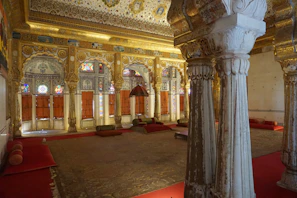 Warm, inviting interior of Rajrasa with royal decor inspired by North Indian palaces.