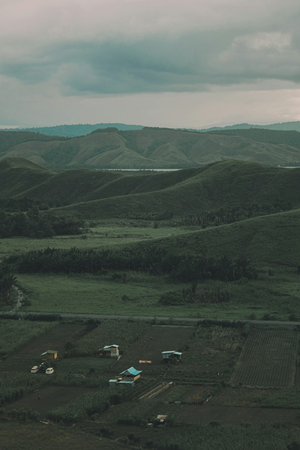 an aerial view of a field and mountains