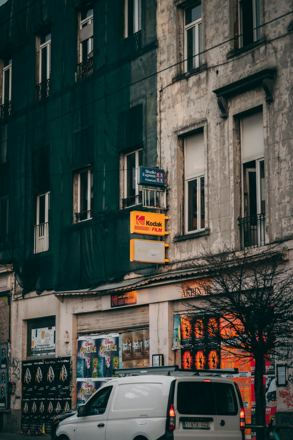 a white van is parked in front of a building