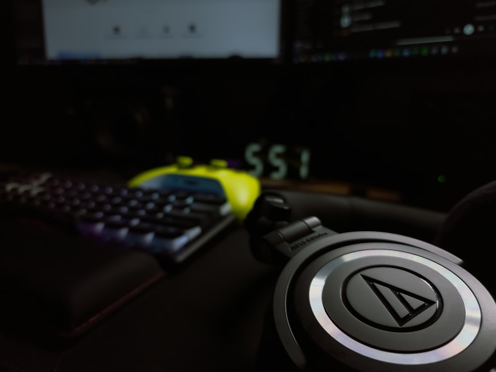 a pair of headphones sitting next to a keyboard