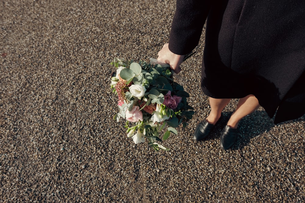 a bouquet of flowers is being held by a woman