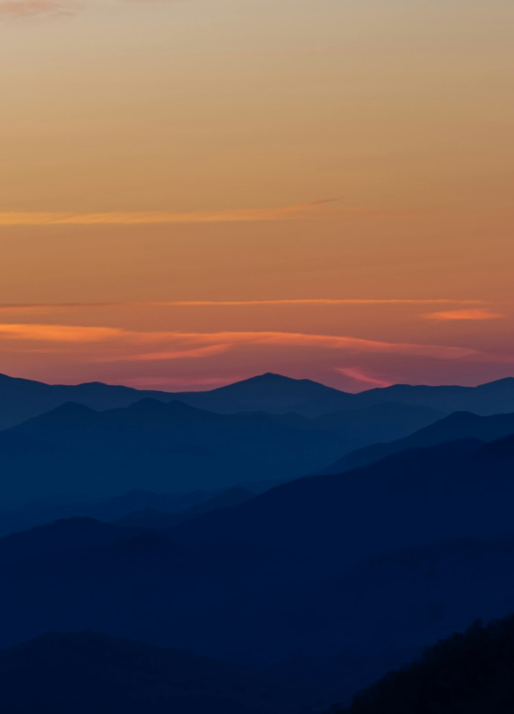 a view of a mountain range at sunset