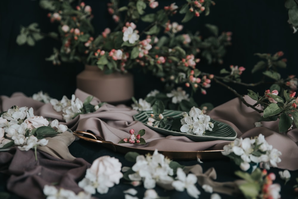 a table topped with a plate covered in flowers