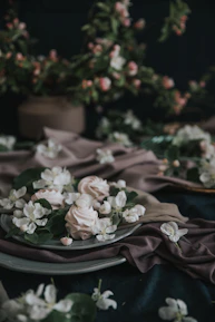 Elegant display of assorted tartes with soft pink and beige backgrounds highlighting their delicate textures.