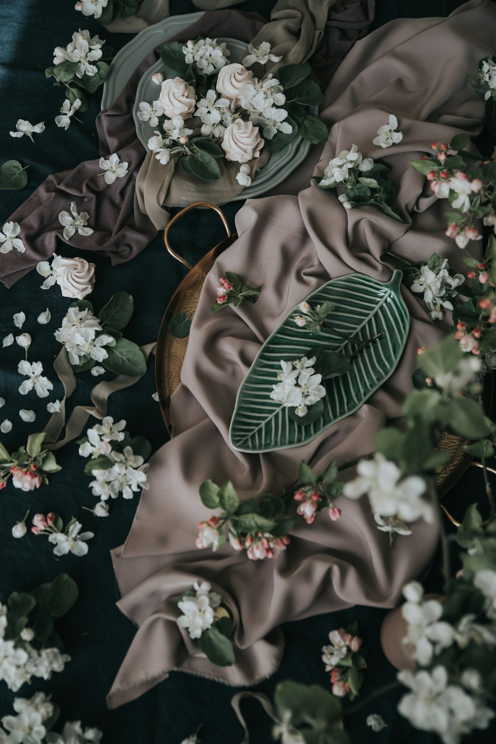 a table topped with a plate covered in flowers