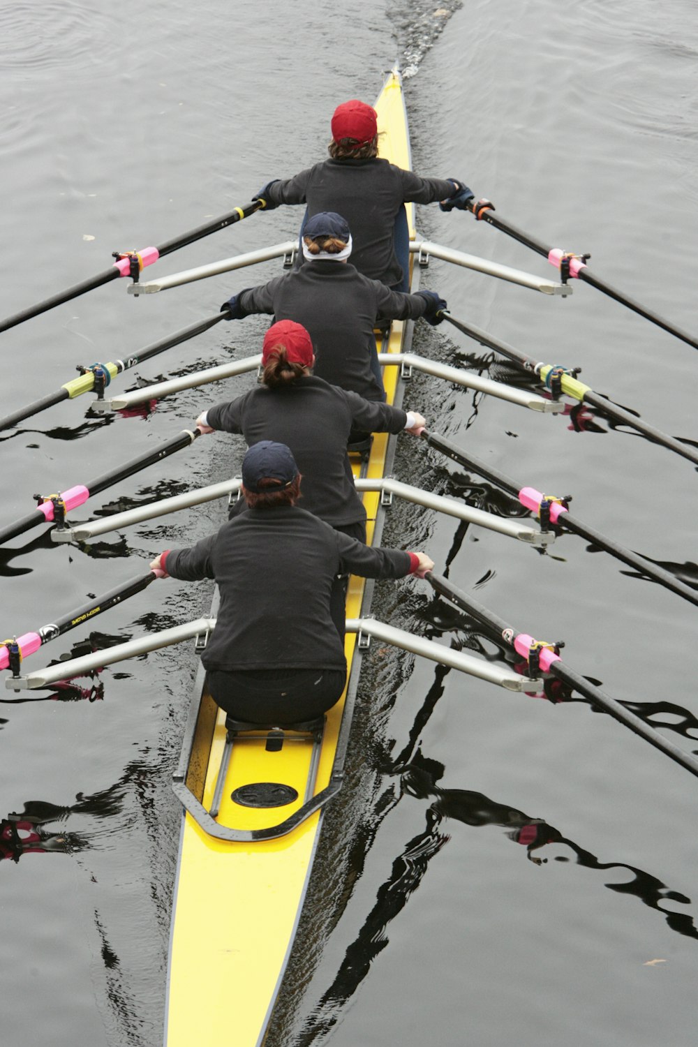 a group of people rowing a boat on a body of water