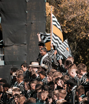 Group photo of the Gauls Bastards club members wearing their yellow and grey jackets.