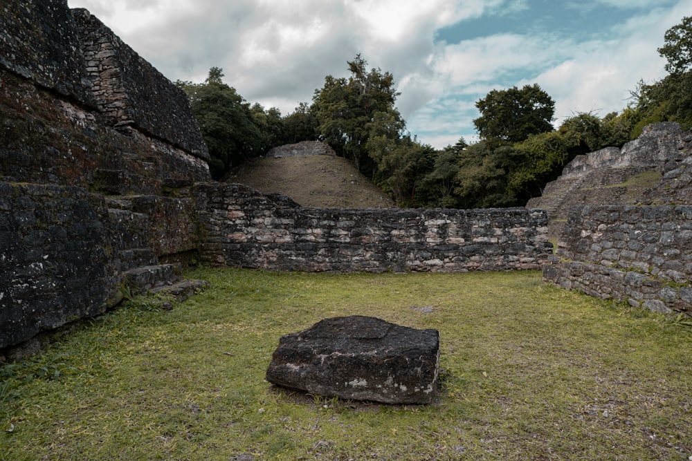 a large rock sitting in the middle of a field