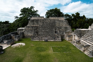 a large stone structure sitting on top of a lush green field