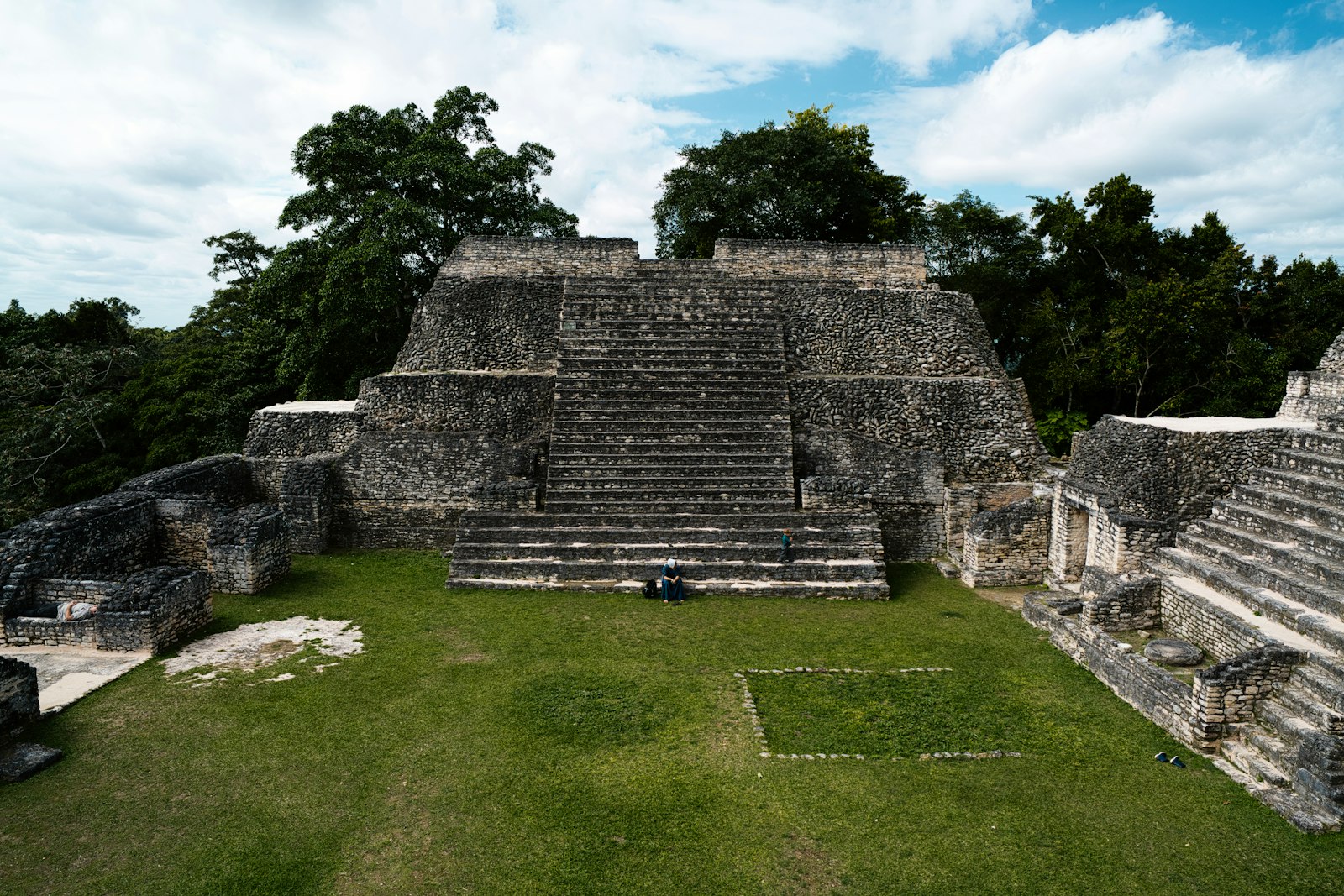 Stepped Maya temple and plaza at Caracol surrounded by tropical forest