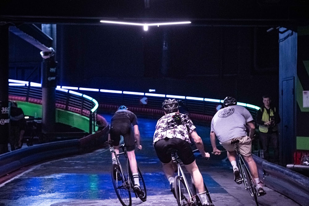 a group of people riding bikes down a street