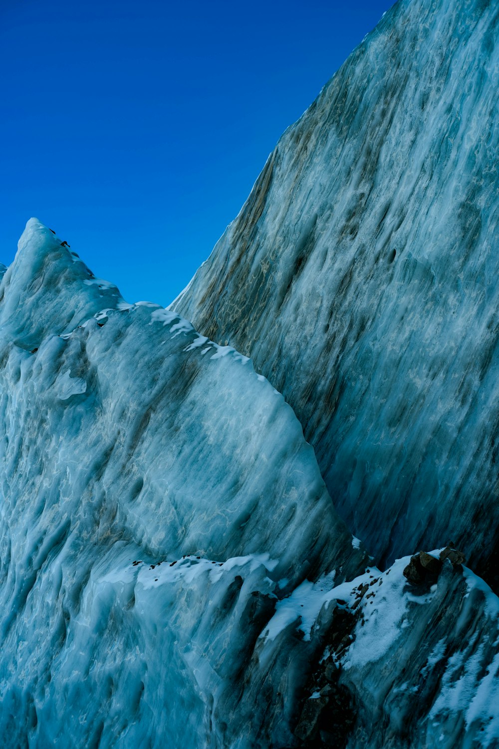 a very large ice mountain with a blue sky in the background