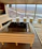 Sunlight filtering through lush plants inside the private sauna room, highlighting wooden benches.