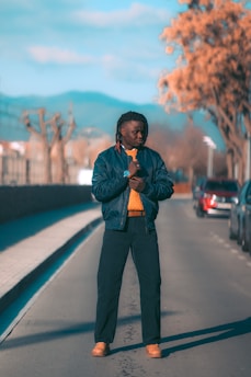 A serene morning scene with a person wearing a clean, minimalist jacket standing confidently on a quiet street, embodying calm readiness.