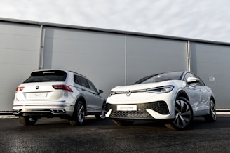two cars parked next to each other in front of a building