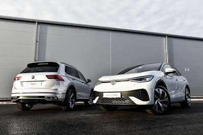 two cars parked next to each other in front of a building