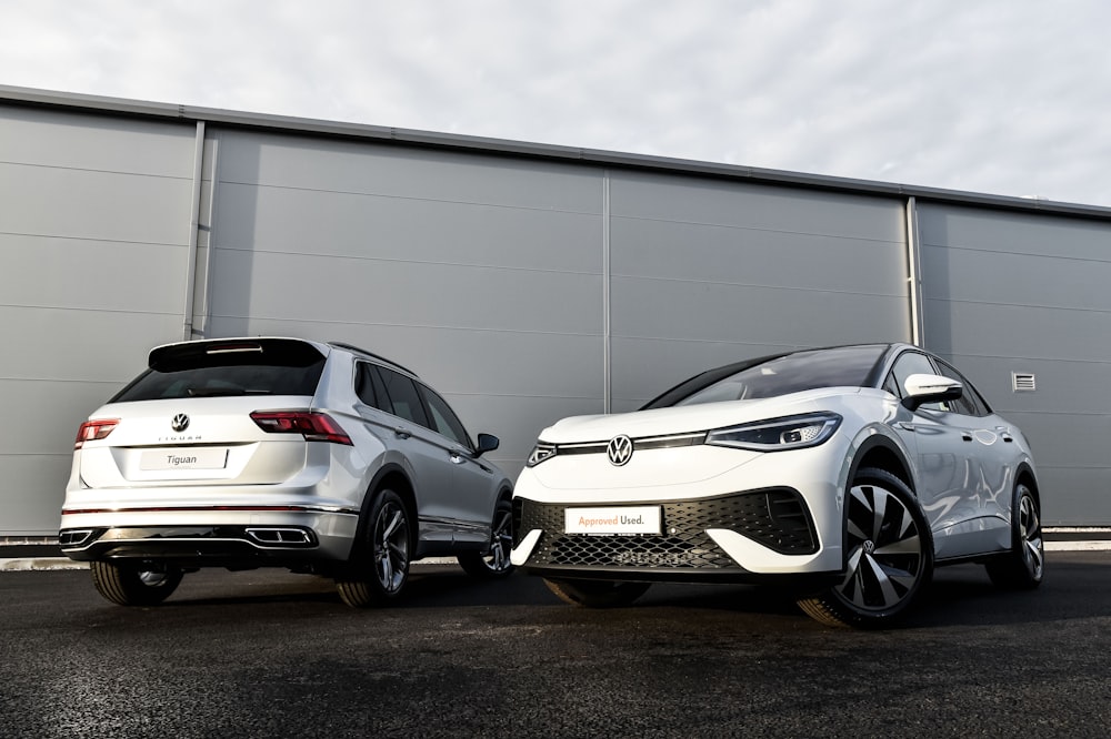 two cars parked next to each other in front of a building