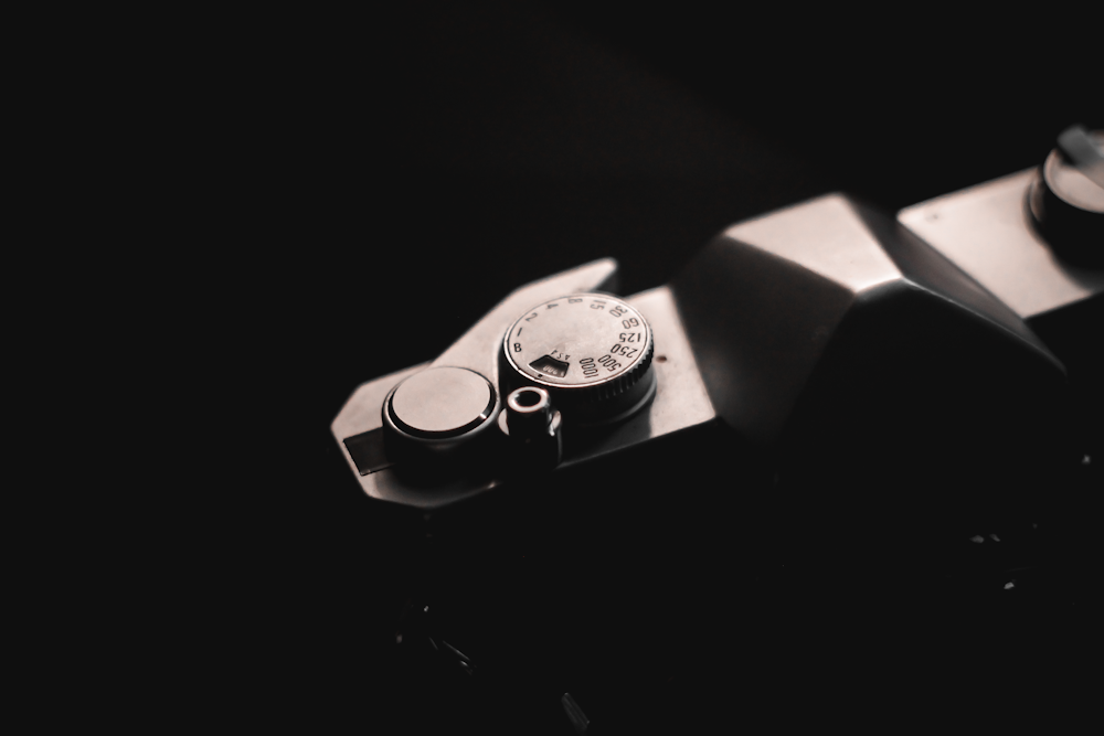 a close up of a watch on a black surface