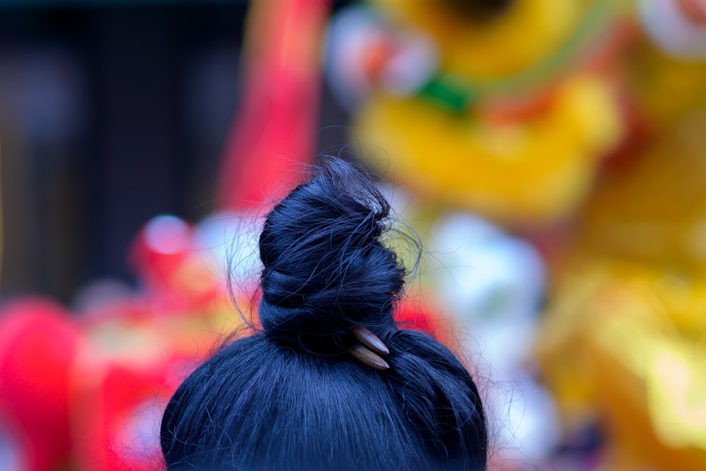 a close up of a woman's hair in a bun