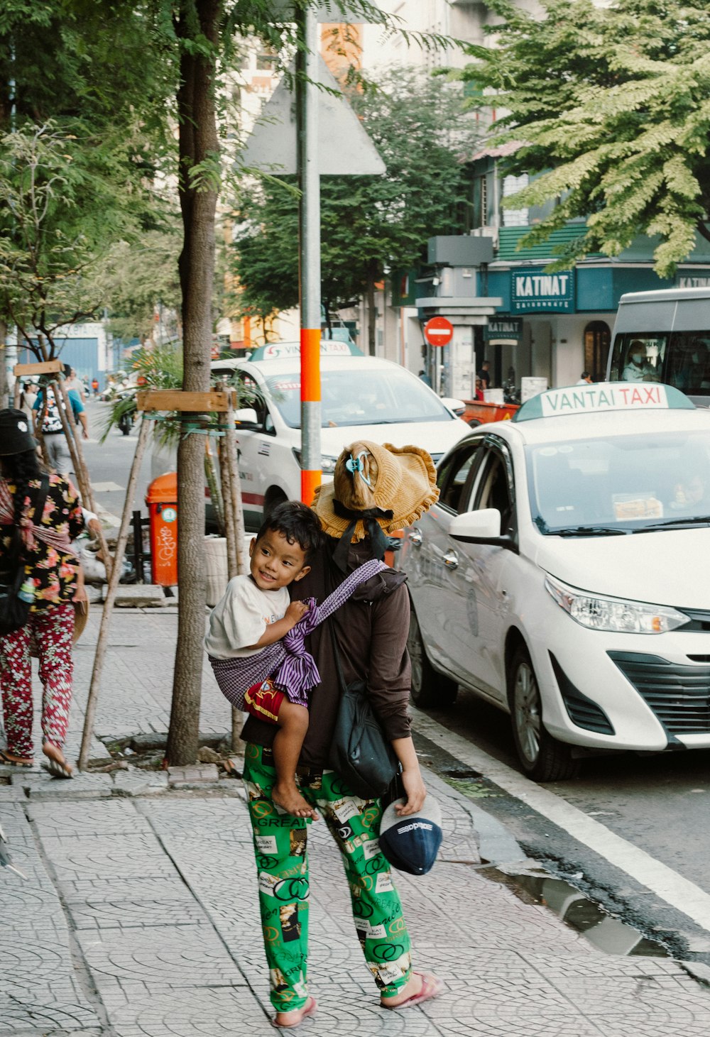 a woman carrying a child on her back