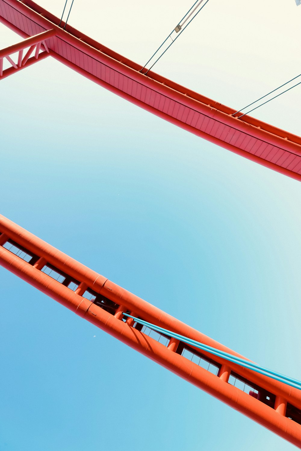 a roller coaster going through a blue sky