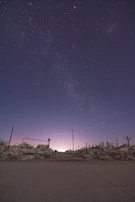 A battlefield scene card depicting a clash under an obsidian sky with golden monolithic statues standing amidst the chaos.