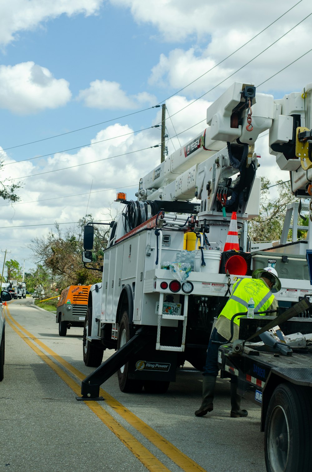 a white utility truck parked on the side of a road