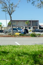 a parking lot with cars parked in front of a building