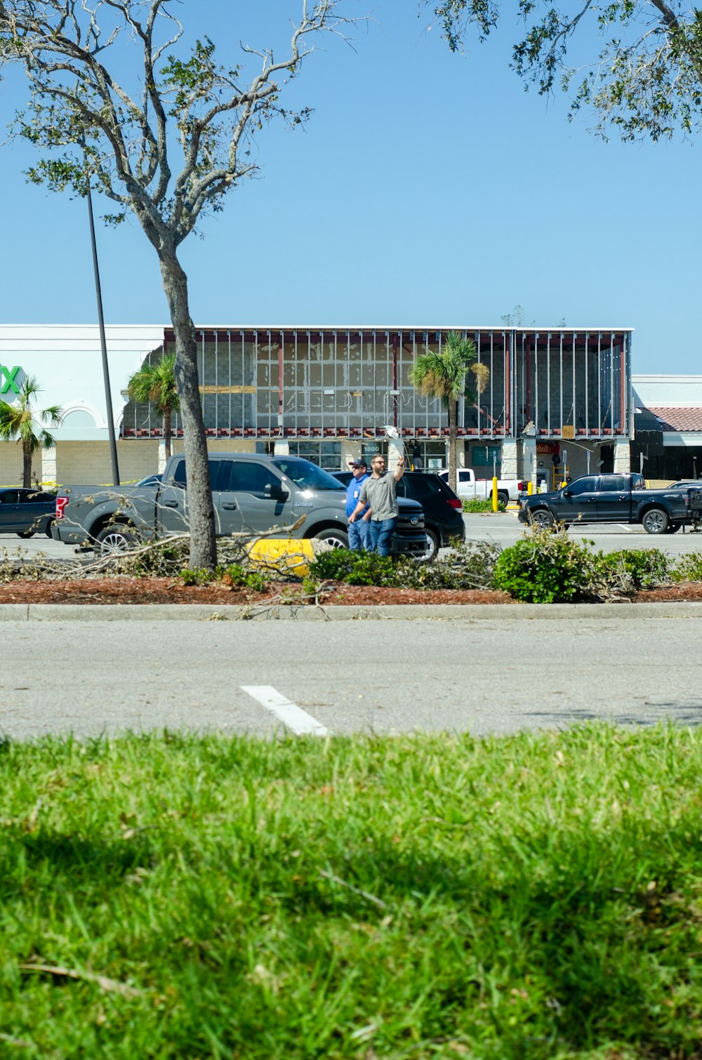 a parking lot with cars parked in front of a building