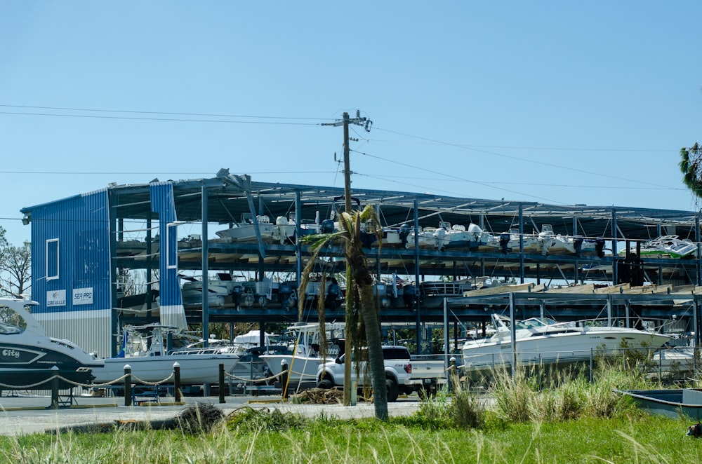 a boat yard with boats and a large building