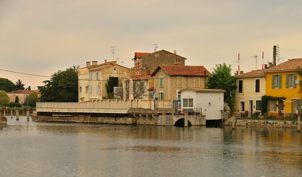 a body of water with houses on the other side of it