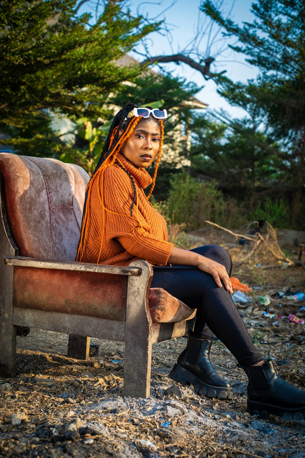 a woman sitting on top of a wooden bench