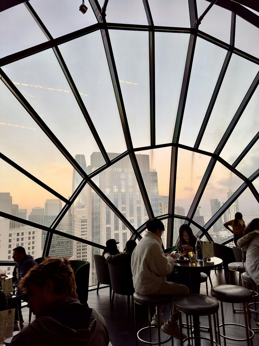 a group of people sitting at a table in a restaurant