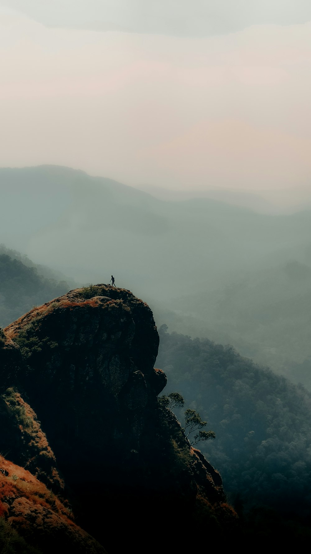 a person standing on top of a mountain