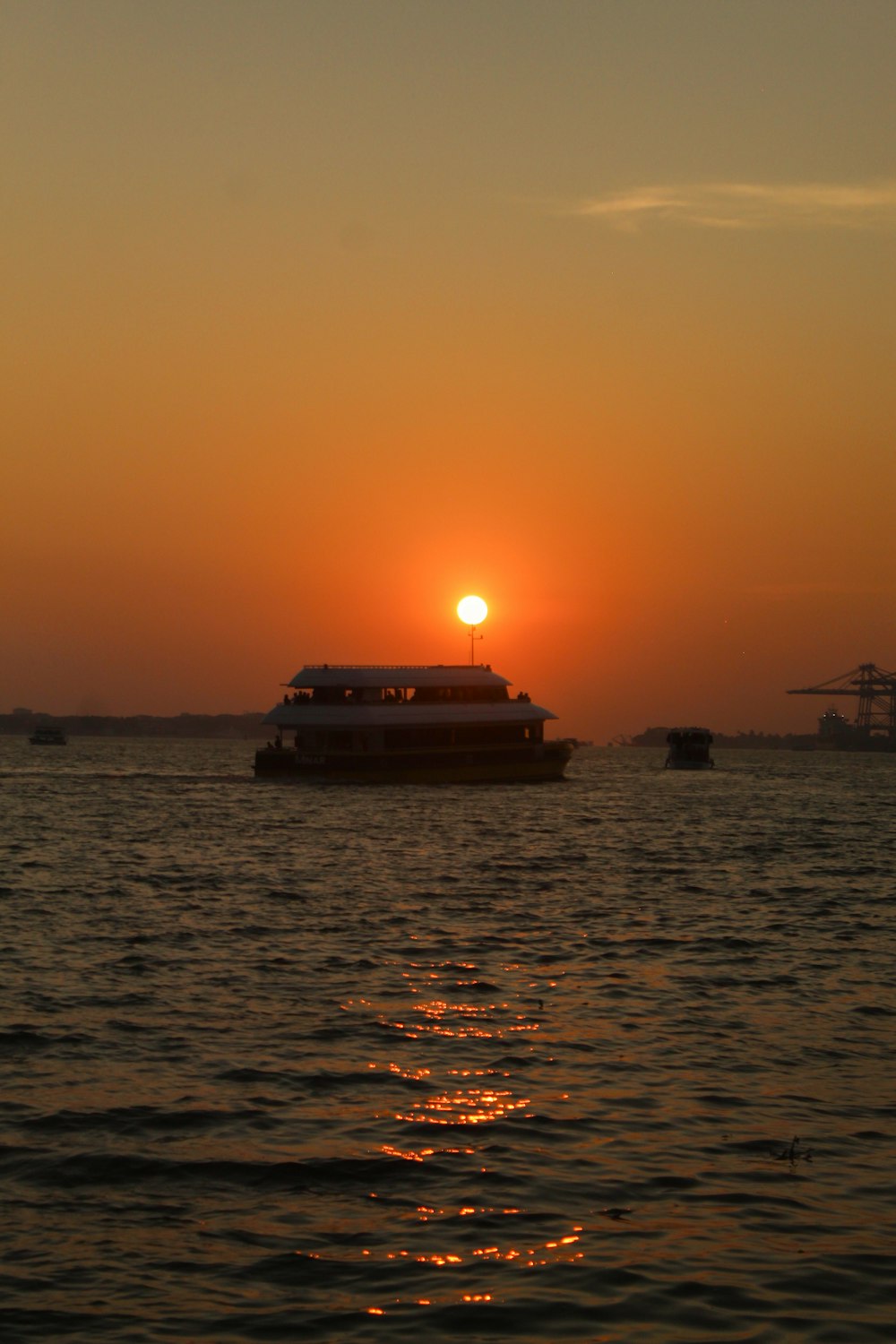 a boat in a body of water at sunset