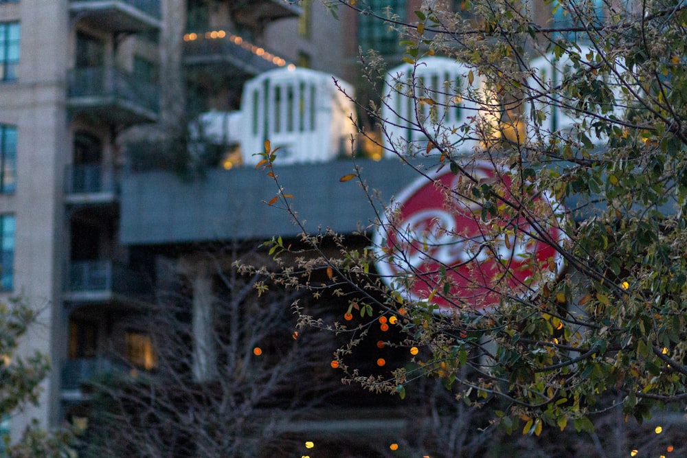 a red and white sign and some trees and buildings