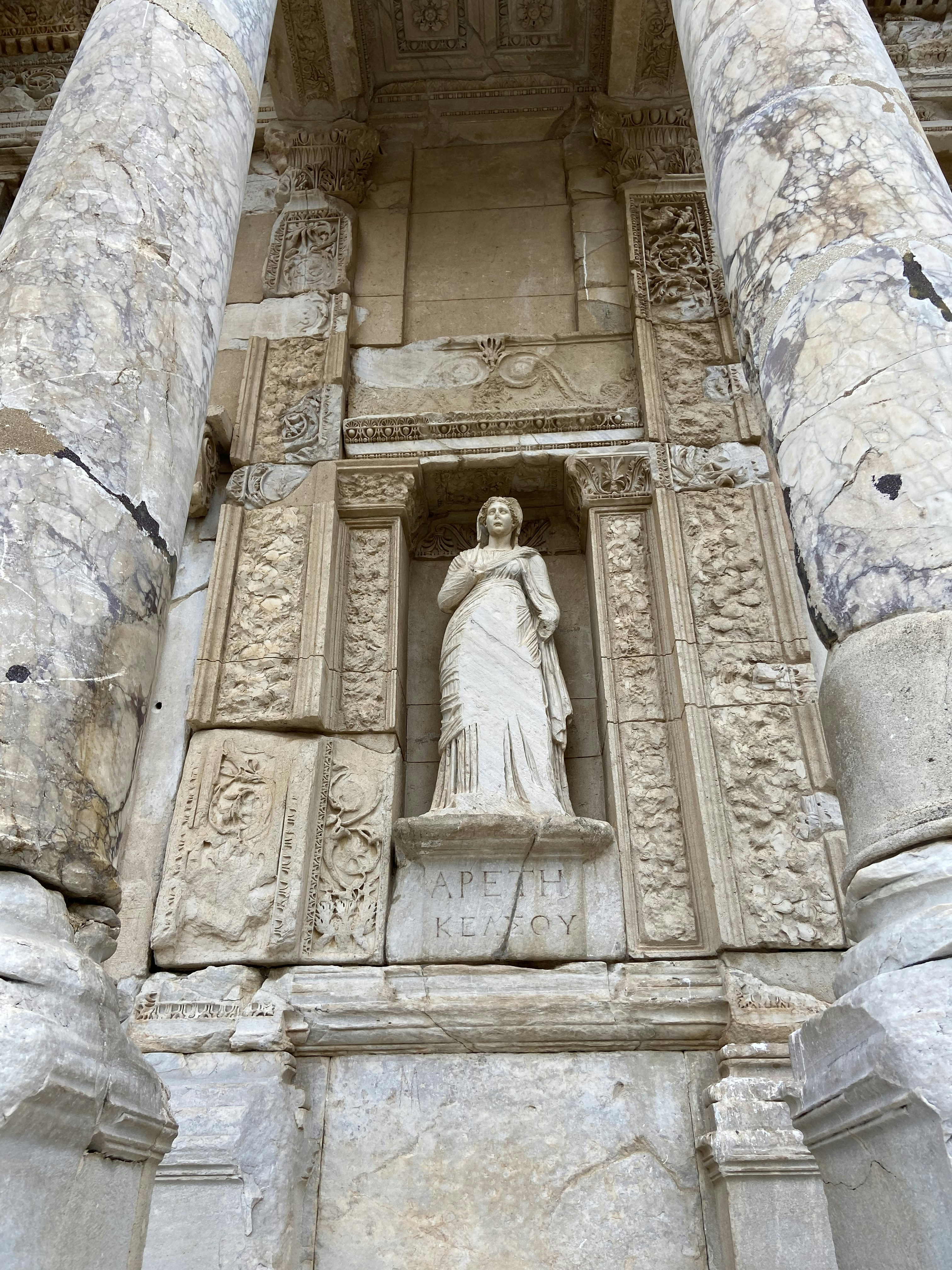 a statue of a woman in a doorway of a building