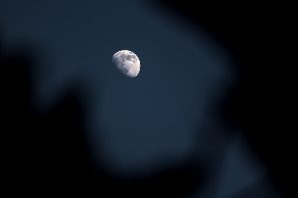 a half moon seen through a telescope lens