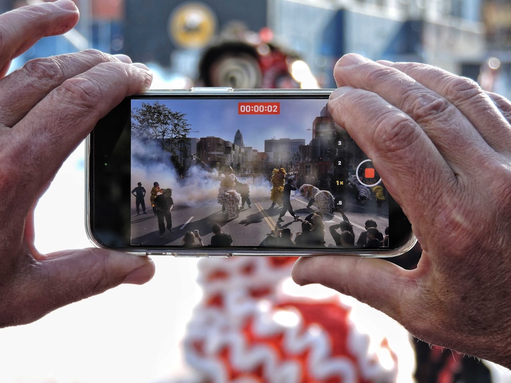 a person taking a picture of a group of people on a street