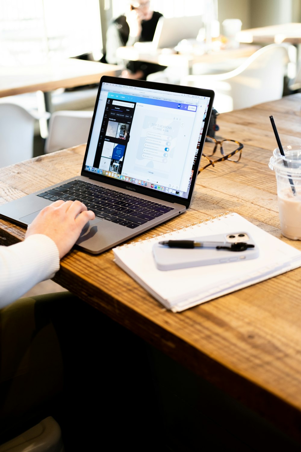 a person sitting at a table with a laptop