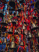 a bunch of bells hanging from a ceiling