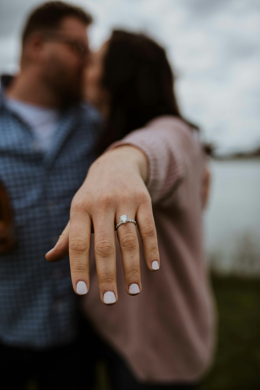 a man and a woman holding hands and kissing