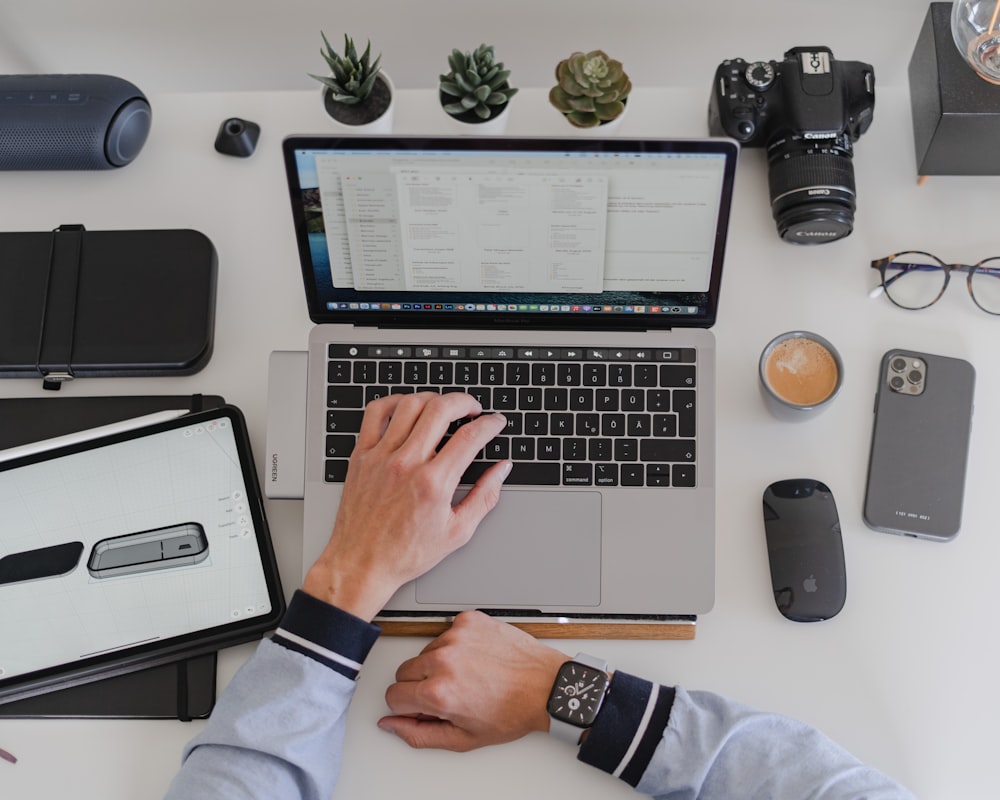 a man sitting at a desk working on a laptop